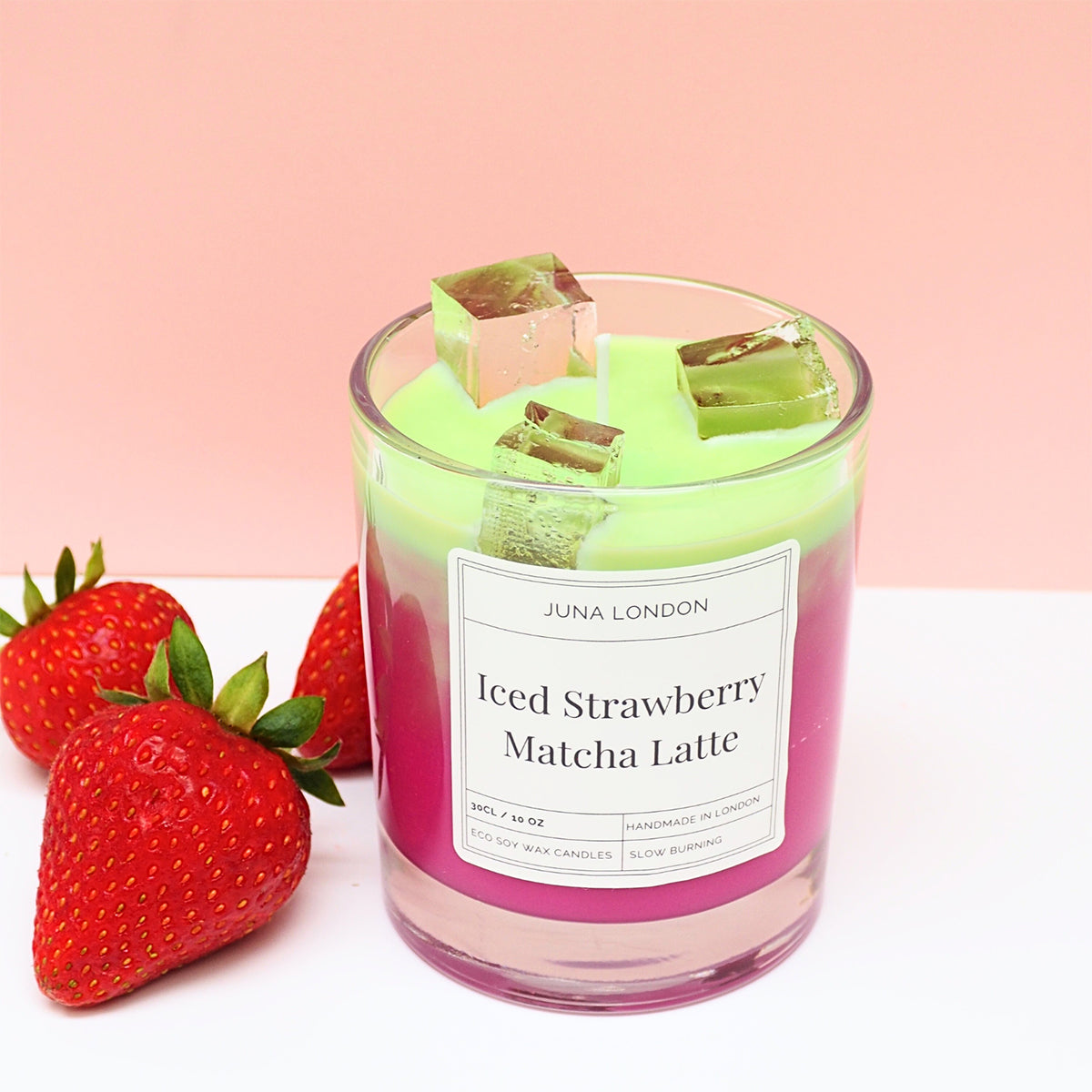 A decorative, vibrant candle to adorn any shelf, dresser or bedside table. Handcrafted from a combination of gel and soy wax, known for their clean and long-lasting burn time. Jelly-like ice cubes are a tactile, hyper-realistic touch making our Iced Strawberry Matcha Latte Candle one of a kind - the perfect gift idea for the matcha-obsessed. 
